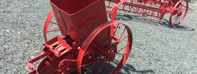 Agricultural artifacts –  A heavy, steel-wheeled seeder, rake, and plow donated by the Holden family